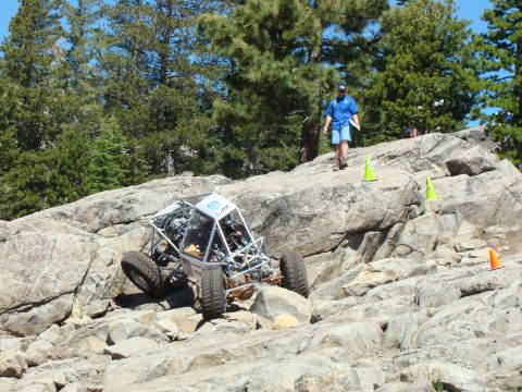 1989 Ford Bronco - A custom off-road buggy tackles a challenging rocky terrain during an event.