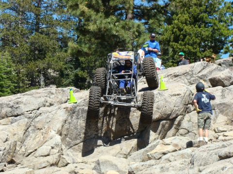 1989 Ford Bronco - Off-road buggy tackling a challenging rocky terrain during an event.