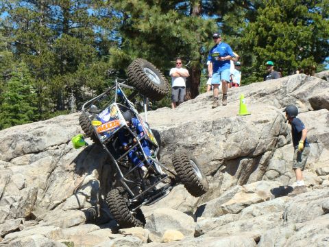 1989 Ford Bronco - An off-road buggy navigates a challenging rocky terrain during an event.