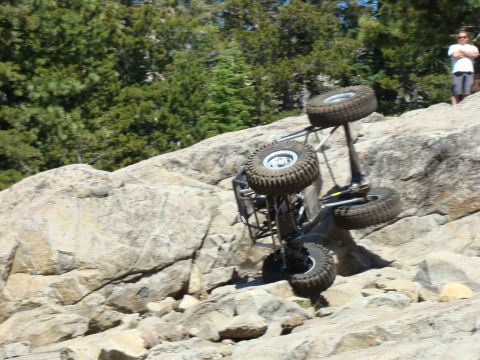 1989 Ford Bronco - Rock crawler on its side during off-road activity.