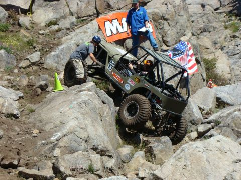 1989 Ford Bronco - A buggy navigates a difficult rocky course with spectators observing.