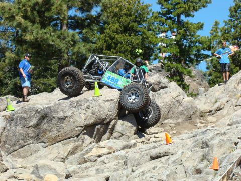 1989 Ford Bronco - A custom-built off-road buggy navigates a challenging rocky terrain during a competition.