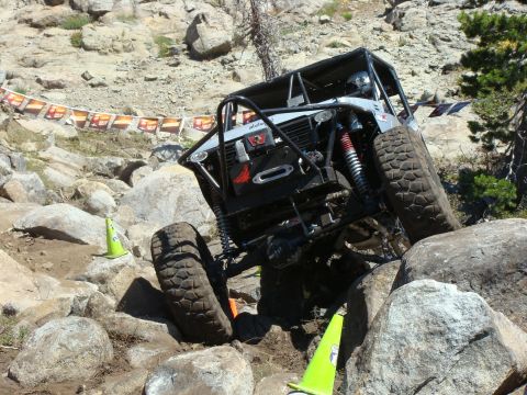 1989 Ford Bronco - Custom off-road buggy tackles a challenging rocky course, demonstrating extreme suspension articulation.