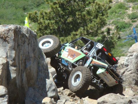 1989 Ford Bronco - A custom-built off-road buggy navigates a challenging rocky terrain during an event.