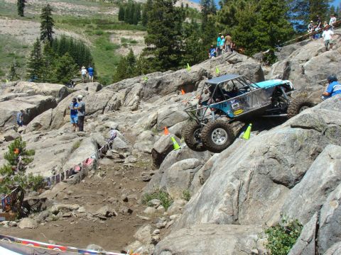 1989 Ford Bronco - A custom-built off-road buggy navigates a challenging rocky terrain during a competition.