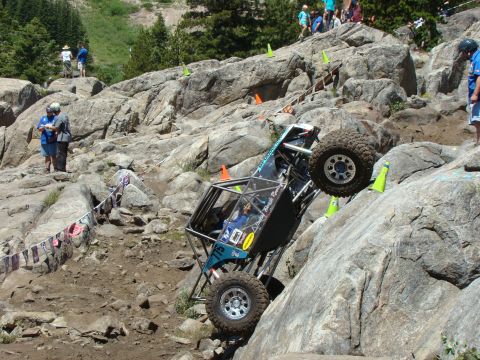 1989 Ford Bronco - This heavily modified off-road vehicle navigates a challenging rocky terrain during an event.