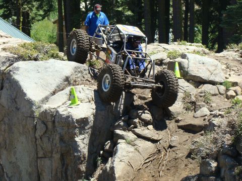 1989 Ford Bronco - Custom off-road buggy tackling a challenging rocky terrain during an event.