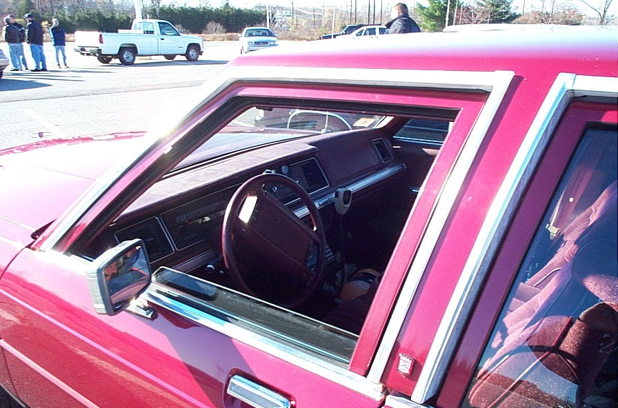 Interior view of a red car's dashboard and steering wheel