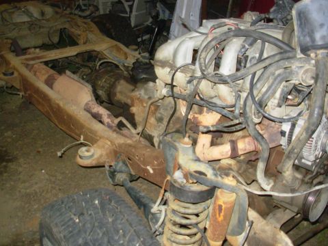 1983 Ford Bronco - The engine and chassis of a 1983 Ford Bronco, showing the front suspension and exhaust system.