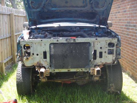 1994 Ford Bronco - Front view of a 1994 Ford Bronco with the hood up and front fascia removed for repairs.