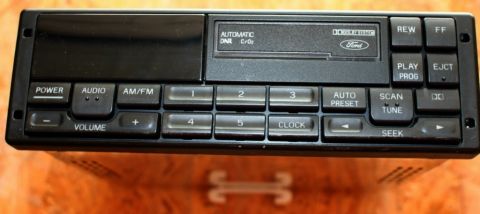 1994 Ford Bronco - This car stereo displays the Ford logo and various control buttons for audio playback and tuning.