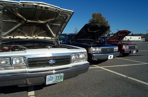 1991 Ford LTD Crown Victoria - Three Ford Crown Victorias from the 1991 model year are lined up with their hoods open.