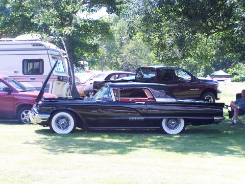 1975 Ford Ranchero - A classic black Ford Fairlane 500 Skyliner is displayed outdoors with its hood open.