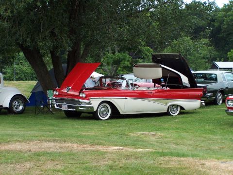 1975 Ford Ranchero - Two-tone 1957 Ford Fairlane convertible at a car show with hoods up.