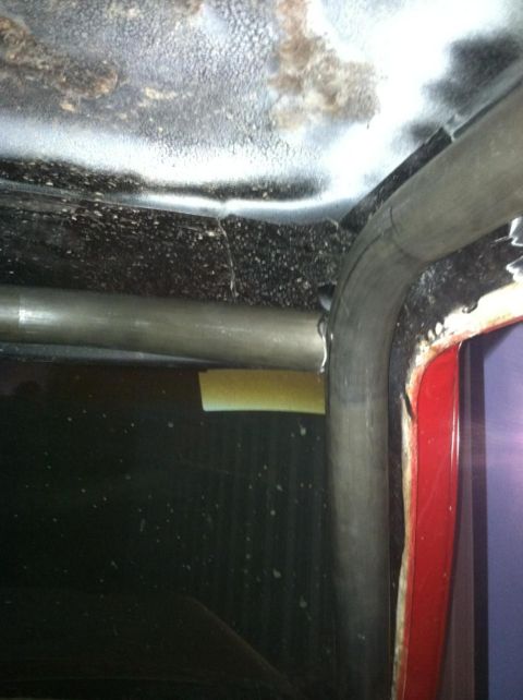 1978 Ford Bronco - Interior view showing roll cage tubing and red trim panel.