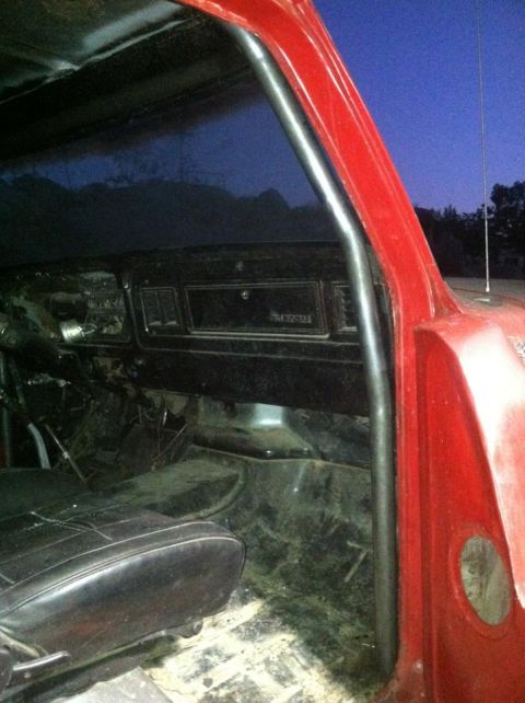 1978 Ford Bronco - The interior of a 1978 Ford Bronco shows a roll cage and dashboard details.