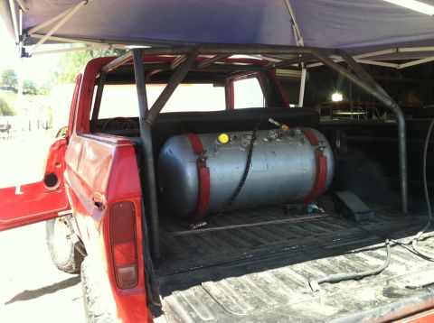 1978 Ford Bronco - 1978 Ford Bronco modified with a roll cage and a large silver tank installed in the bed.