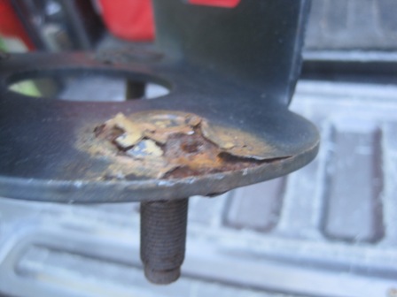 1993 Ford Bronco - A heavily rusted metal component, likely a vehicle part, is shown in close-up with visible corrosion.