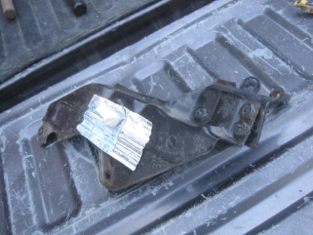 1993 Ford Bronco - A metal bracket with a sticker is shown in the bed of a truck. The registry claims it is from a 1993 Ford Bronco, but this is unconfirmed.