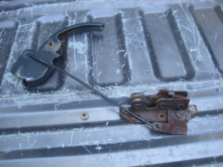 1993 Ford Bronco - Ford tailgate latch mechanism with handle and cable, appears to be from an older model truck or SUV.