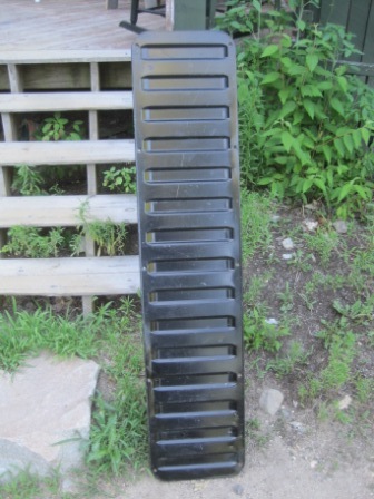 1993 Ford Bronco - Black grille part with horizontal slats, likely from a vehicle. Supermotors logo visible at the bottom.