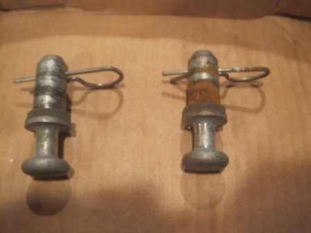 1993 Ford Bronco - Two metal pins with cotter pins are shown, one of which exhibits rust.