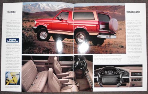 1994 Ford Bronco - Scanned two-page Ford dealer brochure spread for the 1994 Bronco Eddie Bauer, showing a red-and-tan full-size SUV posed in a desert setting…