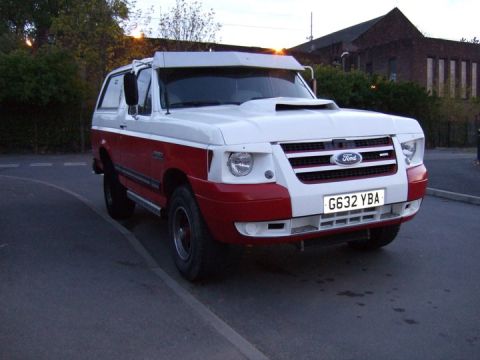 1989 Ford Bronco - This modified Ford Bronco features a prominent hood scoop and a visor above the windshield.