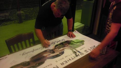 2000 Mercury Grand Marquis - A poster depicting a 2012 Panther is signed by attendees at an event.