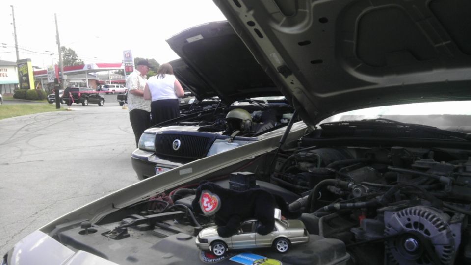 Engine bay of a 2000 Mercury Grand Marquis with hood open