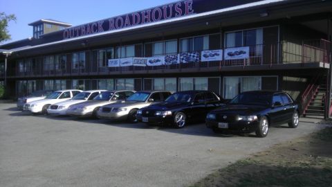 2000 Mercury Grand Marquis - Several Mercury Grand Marquis sedans are parked in front of the Outback Roadhouse building.