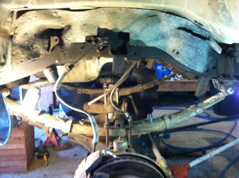 1983 Chevrolet C/K Pickup - Rear suspension components of a 1983 Chevrolet C/K Pickup undergoing maintenance.