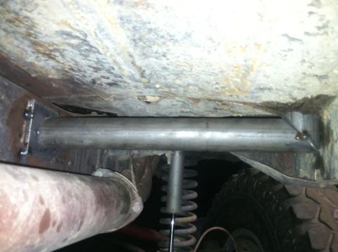 1978 Ford Bronco - Close-up view of the undercarriage, showing custom roll cage tubing and exhaust system components.