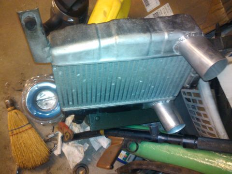 1995 Ford Probe - A radiator part is shown with other miscellaneous items in a cluttered environment.