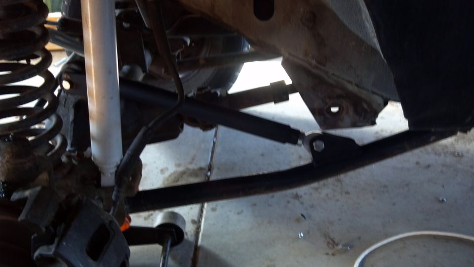 Close-up of 1995 Jeep Cherokee front suspension with shock absorber and control arm