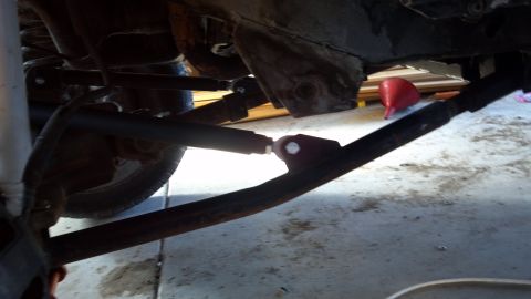 1995 Jeep Cherokee - Close-up of the undercarriage, showing suspension parts and the frame of a vehicle.