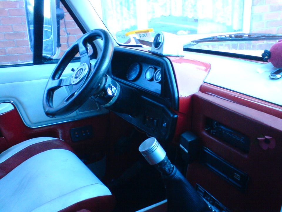 1989 Ford Bronco interior showing aftermarket steering wheel, dashboard gauges, and shifter