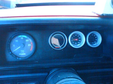 1989 Ford Bronco - The dashboard features several gauges, including a tachometer with 'SCANIA' branding, indicating a possible truck or heavy vehicle interior.
