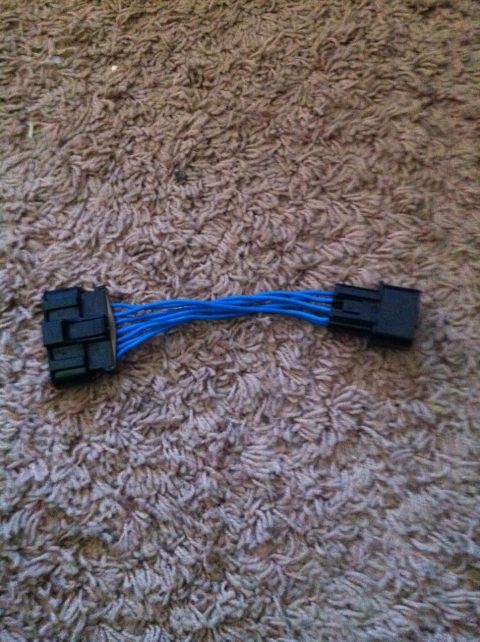 1991 Eagle Talon - This is a wiring harness adapter with blue wires and black connectors, shown on a carpeted surface.