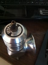 1991 Eagle Talon - A silver blow-off valve is shown, the word 'TURBO' on its top.