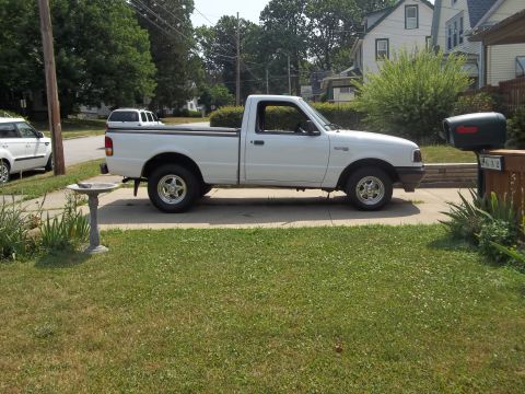 1970 Ford Ranchero - Side view of a white Ford Ranger pickup truck parked on a driveway.