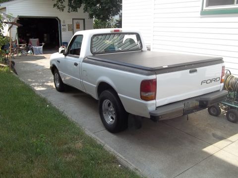 1970 Ford Ranchero - A white Ford Ranger pickup truck is parked in a driveway next to a garage.