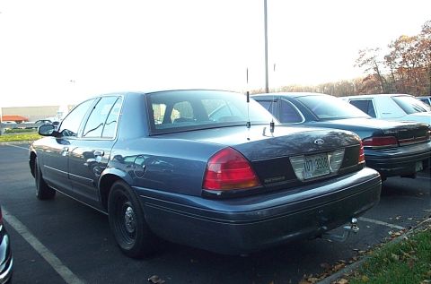 1991 Ford LTD Crown Victoria - A blue Ford Crown Victoria is parked in a lot with other vehicles visible.