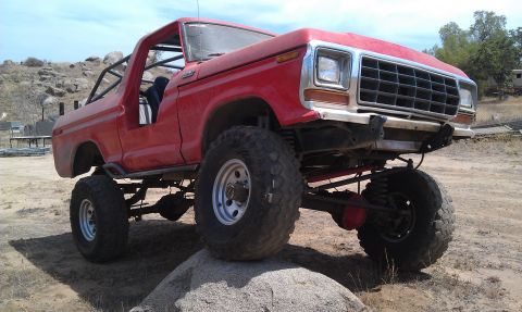 1978 Ford Bronco - This modified SUV is shown with large off-road tires and a prominent roll cage.