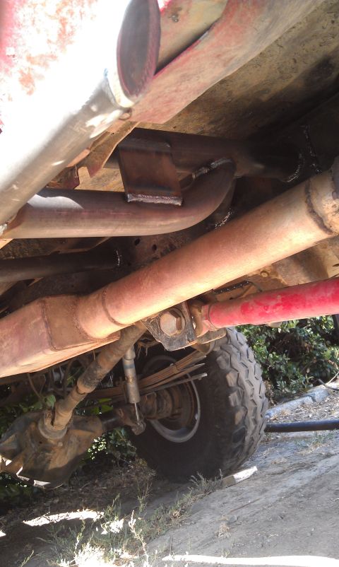 1978 Ford Bronco - A close-up view of the undercarriage reveals exhaust systems and suspension components.