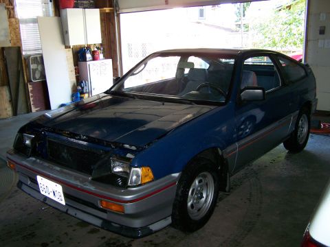 1988 Suzuki Samurai - This blue Honda CRX is parked in a garage with the hood open, showing its front end and side profile.