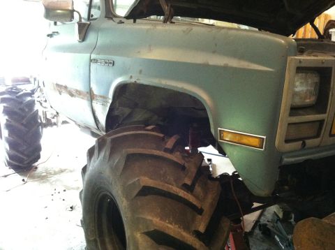 1983 Chevrolet C/K Pickup - This truck has been heavily modified with oversized tires and a lifted suspension, giving it a monster truck appearance.