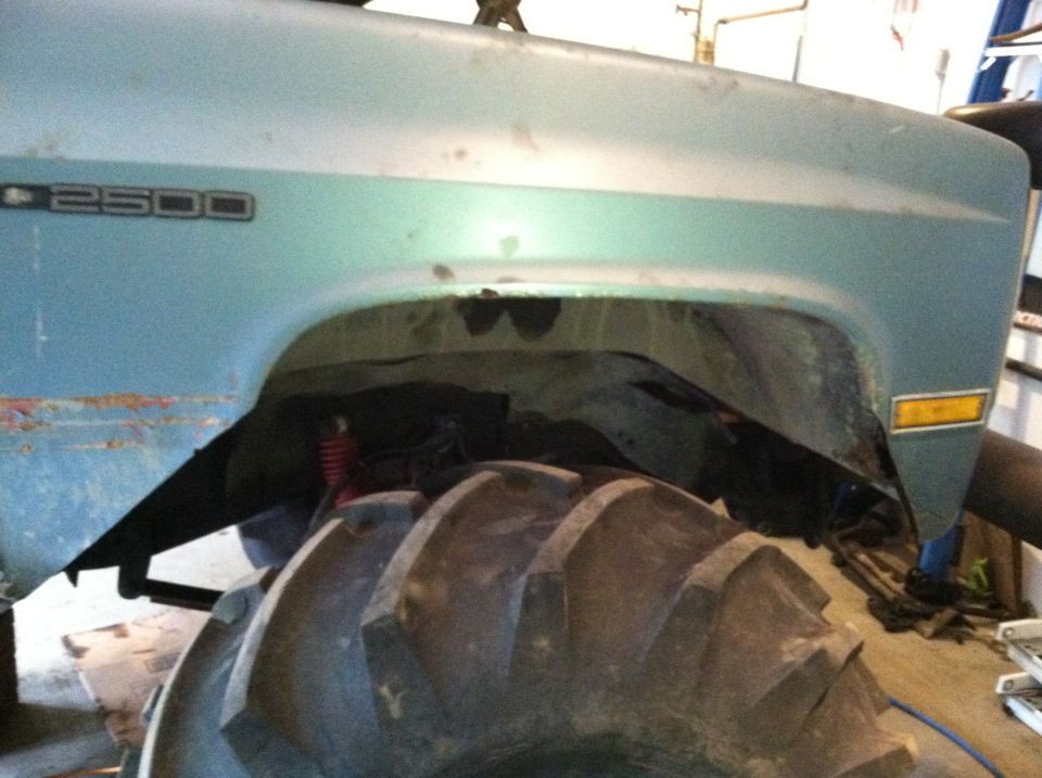 Light blue truck fender with "2500" badge and large tractor tire
