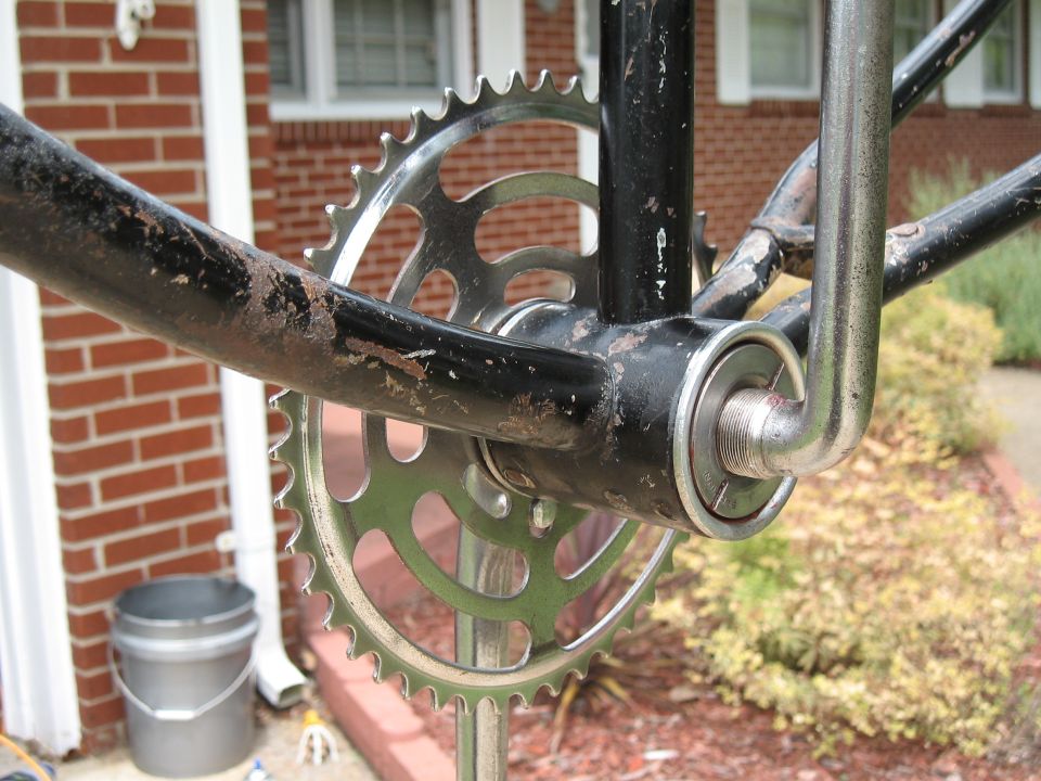 Close-up of a bicycle's crankset with a large chainring