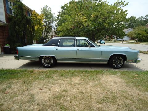 2001 Ford Crown Victoria - A side view of a classic sedan, likely from the late 1970s or early 1980s, parked in a suburban setting.